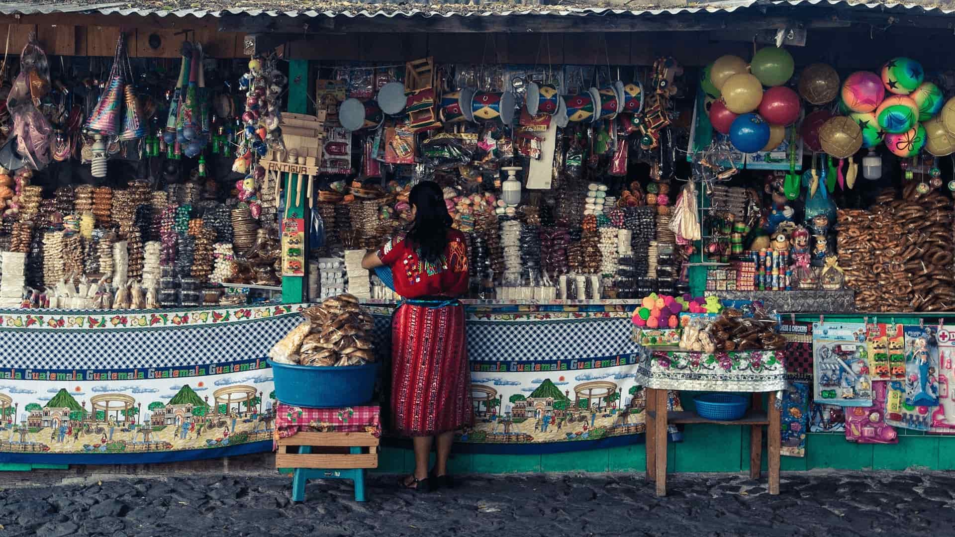 A colourful community storefront decorated with woven textiles
